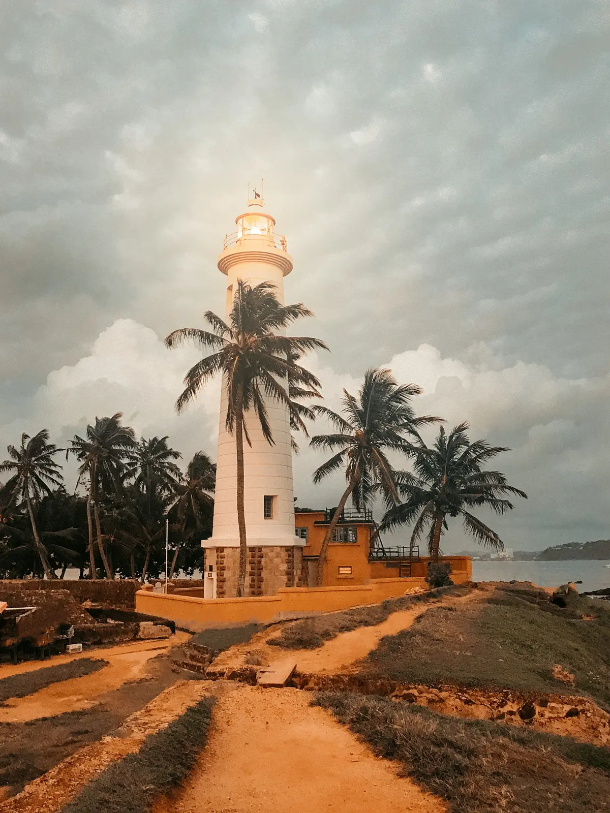 The Galle Fort lighthouse among palm trees on the south coast of Sri Lanka